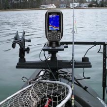 Fish finder attached to kayak on the water with fishing gear